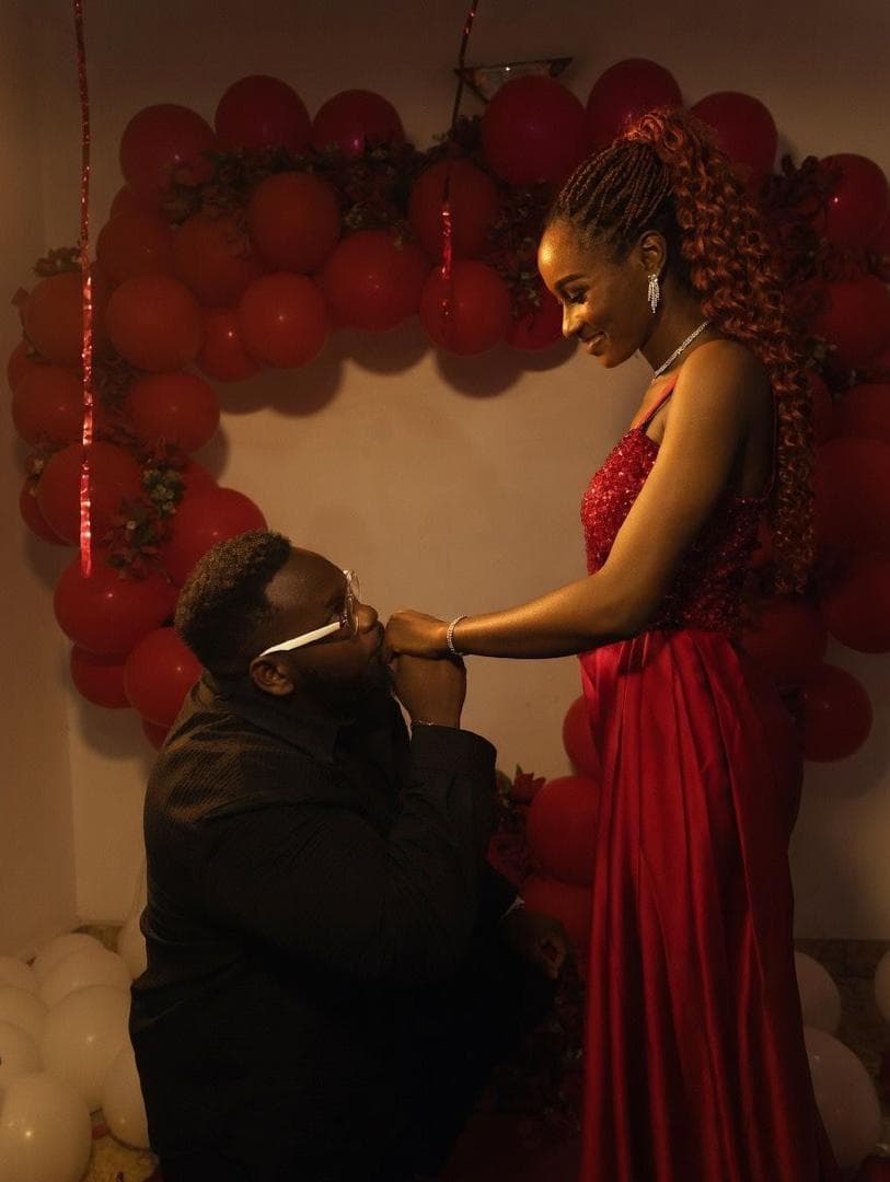Ifeanyi kissing Gabrielle's hand at their engagement